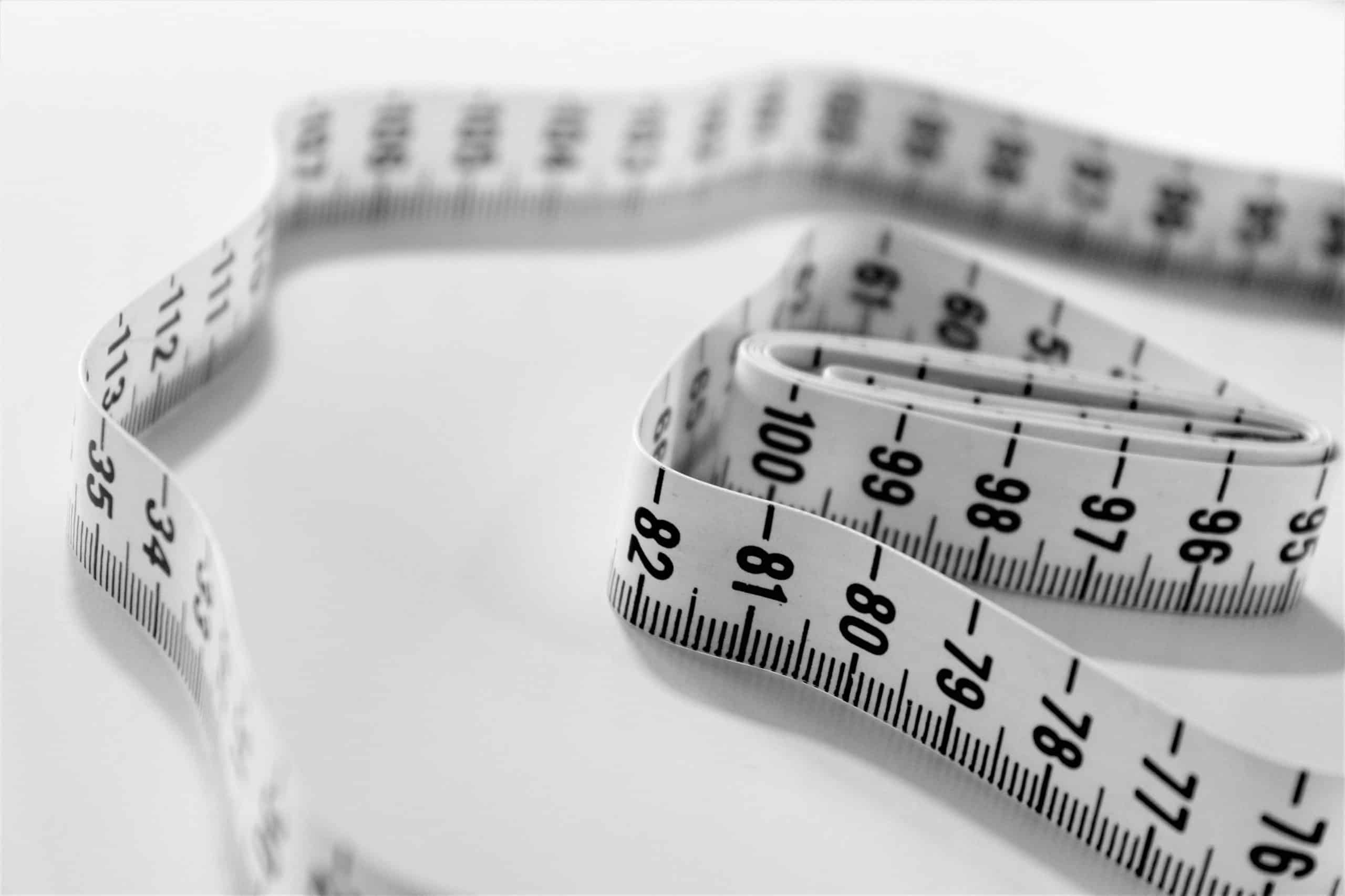 white-tape-measure folded-up-on-white-background
