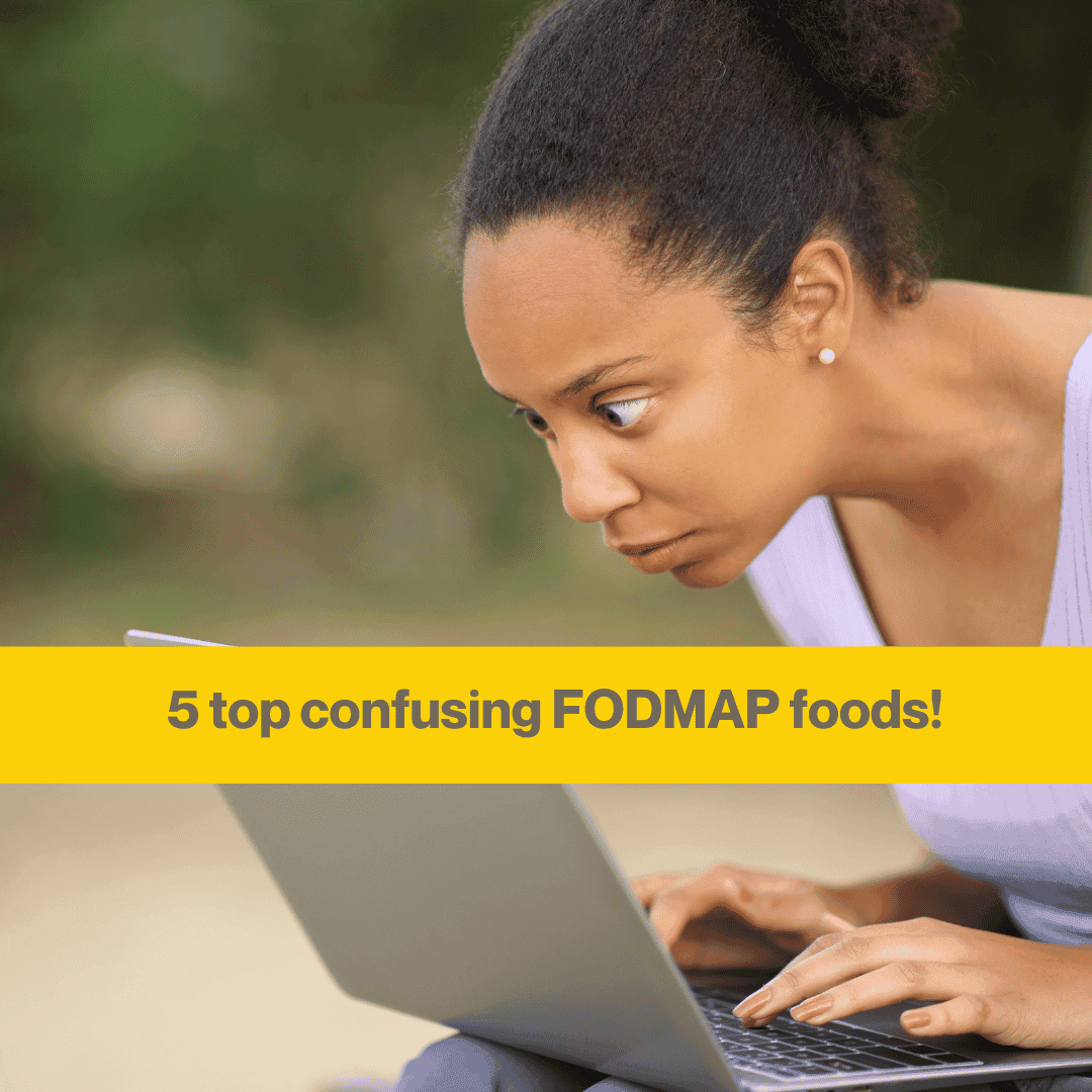 Woman staring closely at her laptop screen, eyes slightly bulging. She's got black hair in a ponytail wearing a white top.